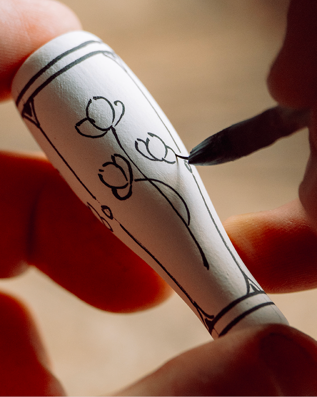 Royal Delft artisan painting a lever handle by hand