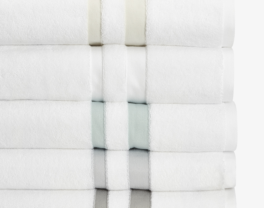 Made in Portugal, these invitingly soft, 700-gram towels feature handsome ribbon detailing and envelop you in comfort. Woven from pure triple-ply cotton for long-lasting quality, they’re wonderfully dense, thick and absorbent.