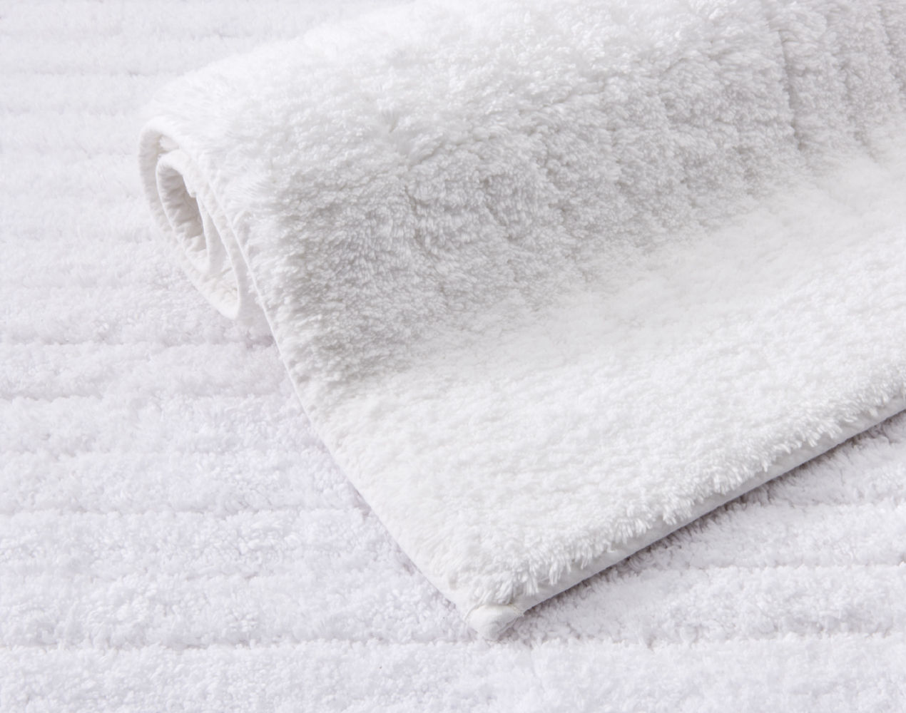 Its 100% cotton composition, paired with unique detailing, brings in refined design utility to bath.